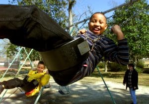 Professional family events photography may include kids playing on a swing enjoying a chilly afternoon